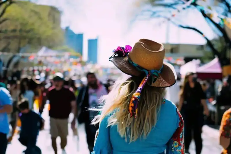Festive Texas celebration gathering showcasing live performance stages and community food stalls