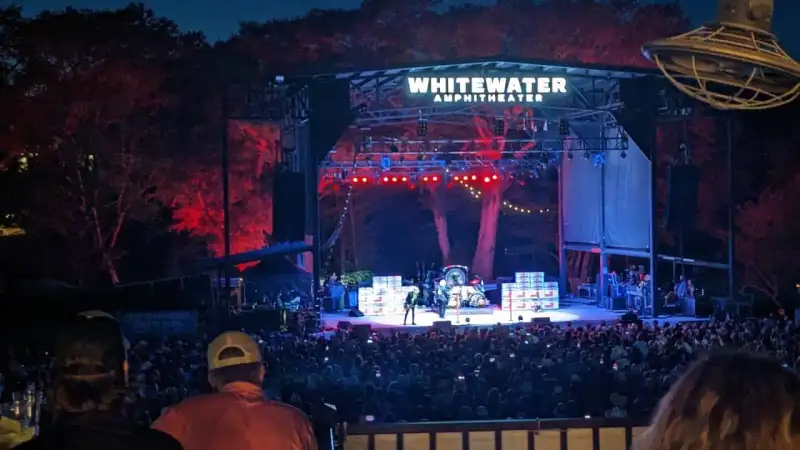 Whitewater Amphitheater open-air stage and general admission gravel standing area along the Guadalupe River in New Braunfels TX