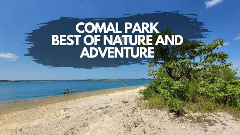 Pebble shoreline and turquoise waters of Comal Park swim beach on the south shore of Canyon Lake