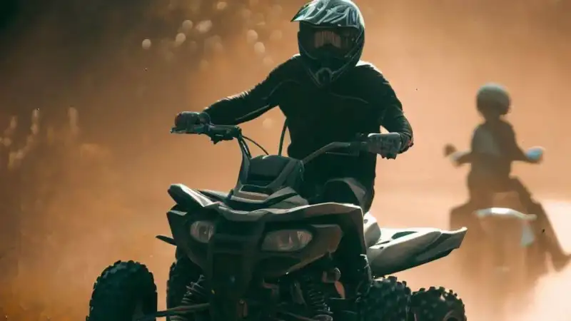 Riders piloting four-wheel ATVs and side-by-side utility vehicles along muddy forest trails near Houston Texas