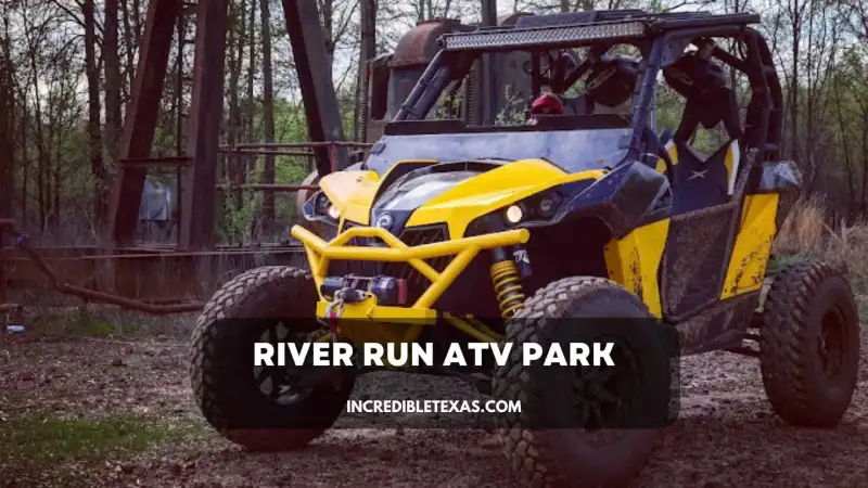 All-terrain vehicles and four-wheelers lined up along the wooded trail system at River Run ATV Park in Jacksonville Texas