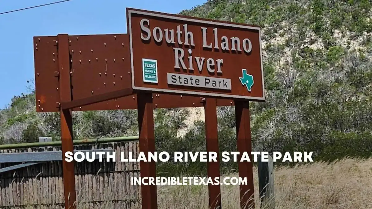 South Llano River flowing gently past limestone canyon bluffs and autumn pecan trees in Junction Texas