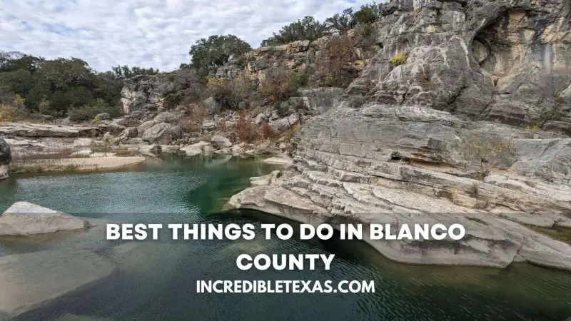 Scenic view of the limestone riverbed and clear running water at Blanco State Park surrounded by bald cypress trees in the Texas Hill Country