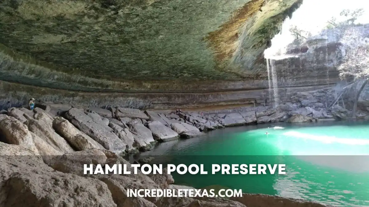Natural limestone grotto and 50-foot waterfall cascading into Hamilton Pool near Dripping Springs Texas