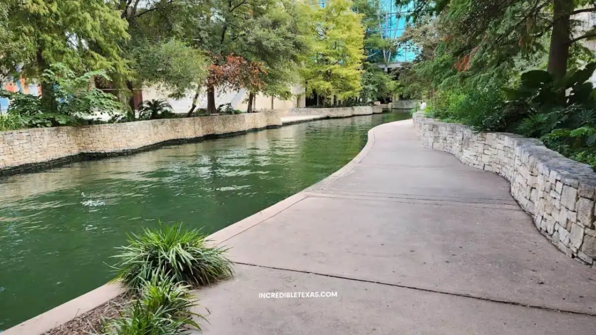Landscaped lawns and walking plazas at Hemisfair with Tower of the Americas in background