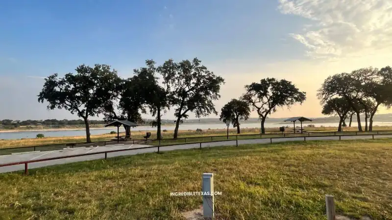 Waterfront campsite and boat ramp view at Cranes Mill Park along Canyon Lake
