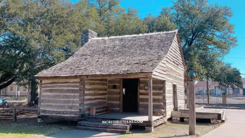 Historic pioneer buildings and green grounds at Dallas Heritage Village in Old City Park