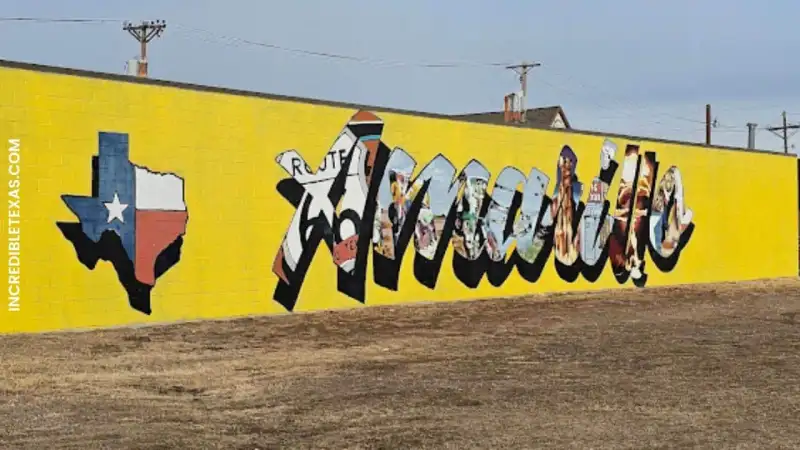 Ten vintage spray painted Cadillacs buried nose down in an open agricultural field at Cadillac Ranch in Amarillo Texas