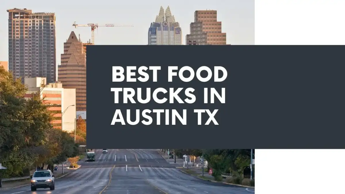 A row of colorful Austin food trucks lined up under cedar elm trees with picnic benches