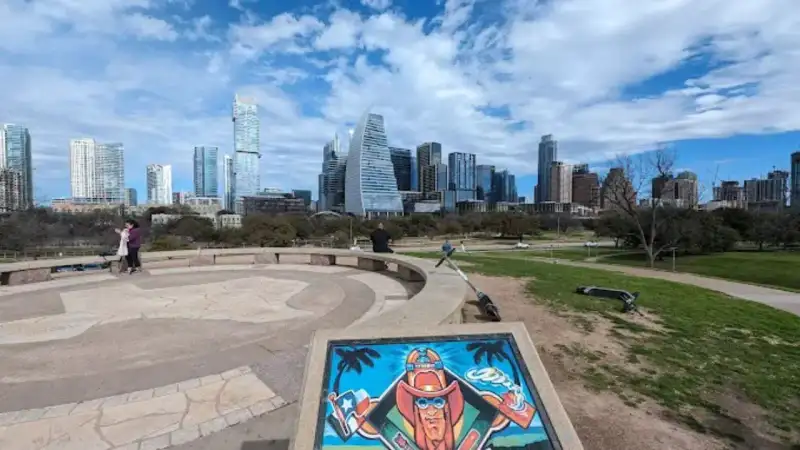 Panoramic view of Butler Metro Park Austin TX with green lawns and downtown city skyline