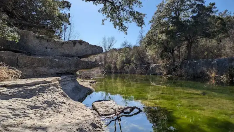 Limestone ledges and shallow spring-fed wading pools at Bull Creek District Park in northwest Austin