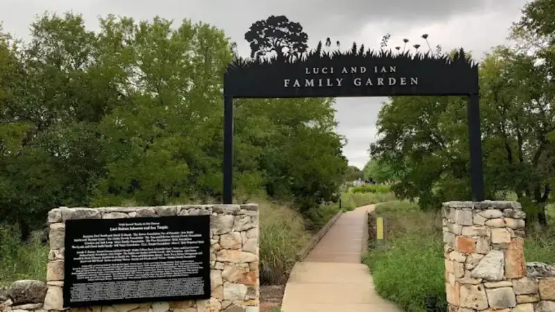 Blooming native wildflowers and stone architecture at Lady Bird Johnson Wildflower Center in Austin Texas
