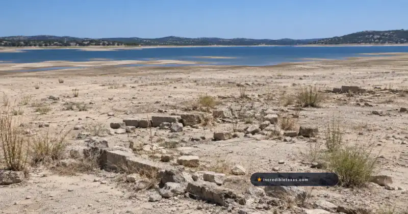 Low limestone foundations on the drought-exposed shore of Old Bluffton beneath Lake Buchanan, Texas