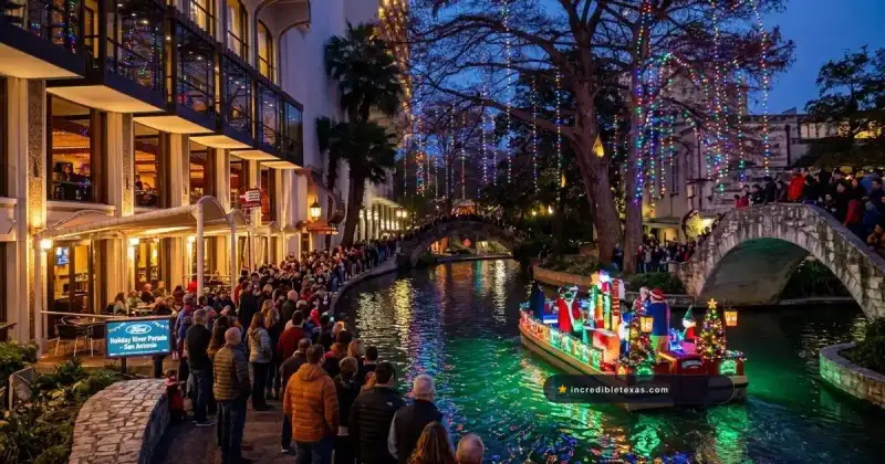 Illuminated holiday barge passing under stone bridge along the San Antonio River Walk draped in Christmas lights