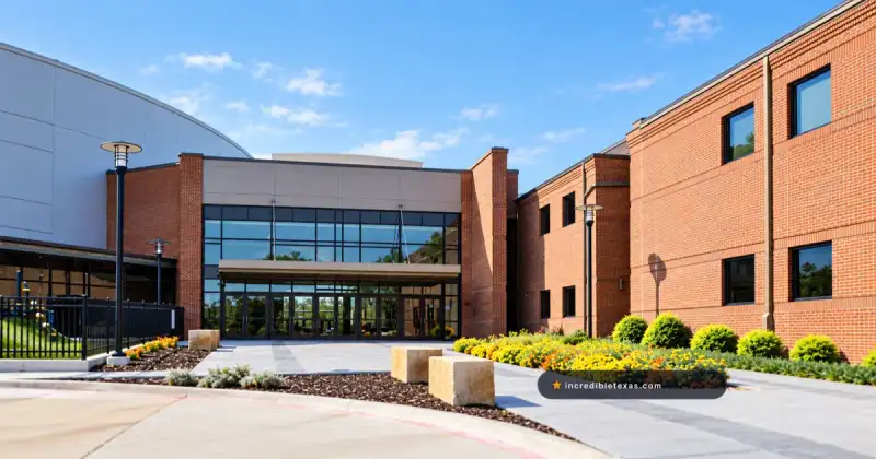 Glass north entrance at Gateway Church Dallas between red-brick wings and its curved worship center