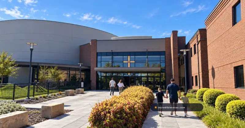 Glass north entrance at Gateway Church Dallas between brick wings and a rounded worship center