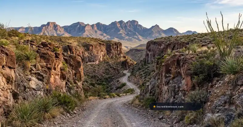Rugged dirt and gravel road winds through volcanic cliffs of Pinto Canyon toward the Chinati Mountains in West Texas