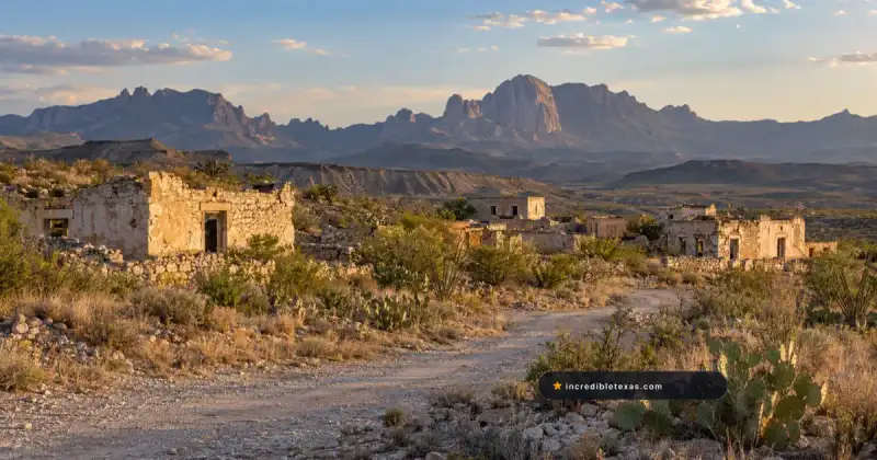 Weathered limestone buildings in Terlingua ghost town beneath the Chisos Mountains