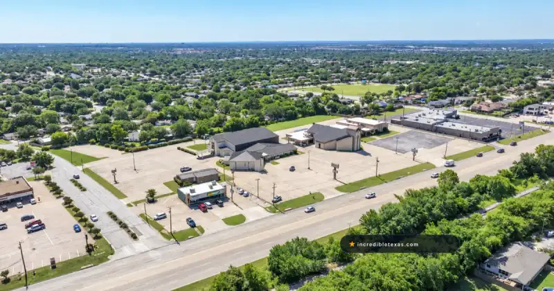 Aerial view of The House church campus in Fort Worth, showing its worship building and parking along Denton Highway