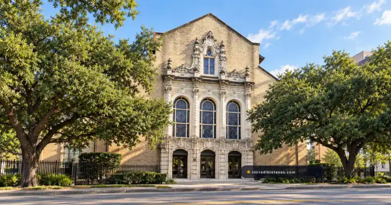 Ornate stone entrance and arched stained-glass windows at University Baptist Church on Guadalupe Street in Austin