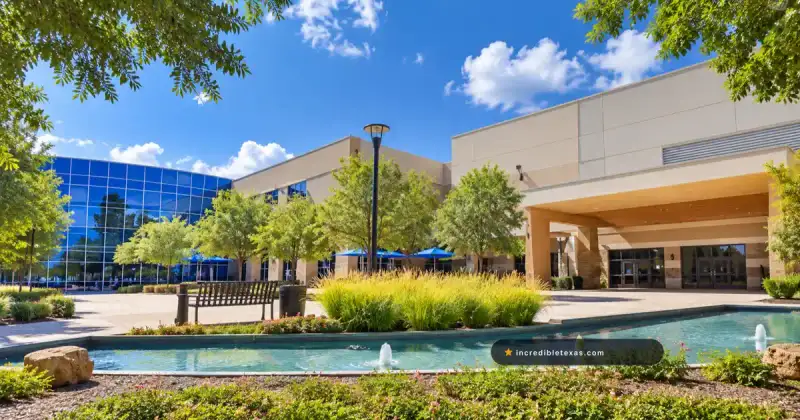 Blue-glass sanctuary and landscaped fountain courtyard at Woodlands Church in The Woodlands