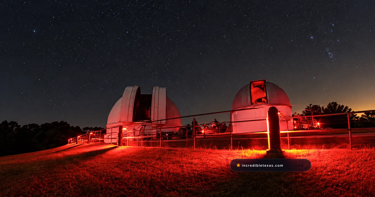 Two telescope domes at George Observatory under red star-party lights at Brazos Bend State Park near Houston