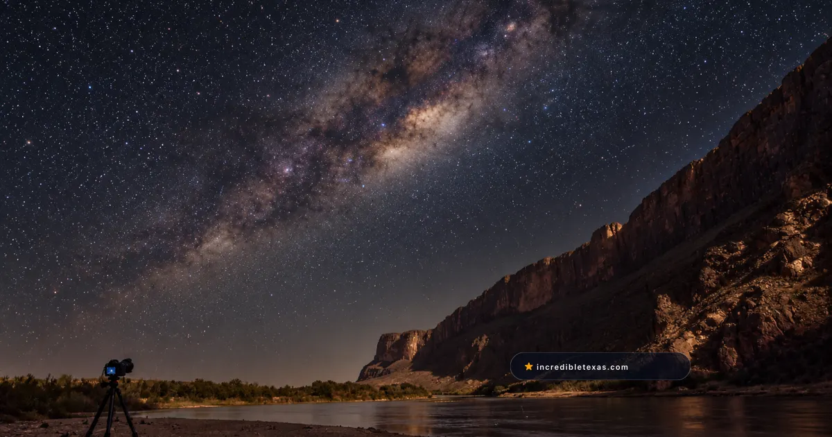 A camera on a tripod captures the Milky Way above the Rio Grande at Santa Elena Canyon in Big Bend