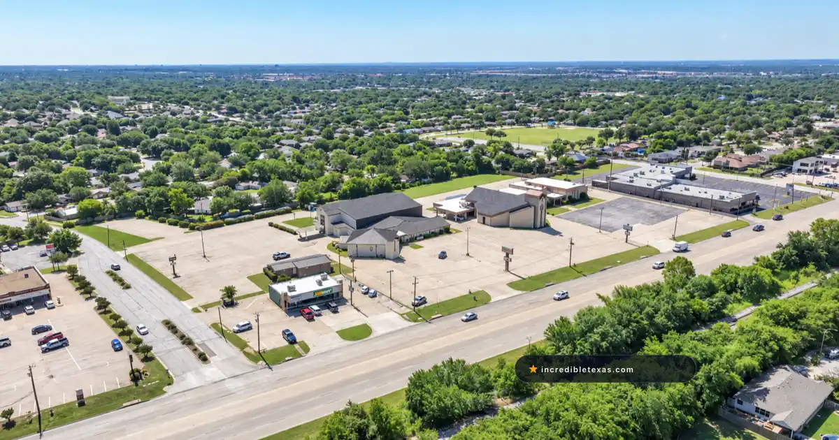 Aerial view of The House church campus in Fort Worth, showing its worship building and parking along Denton Highway