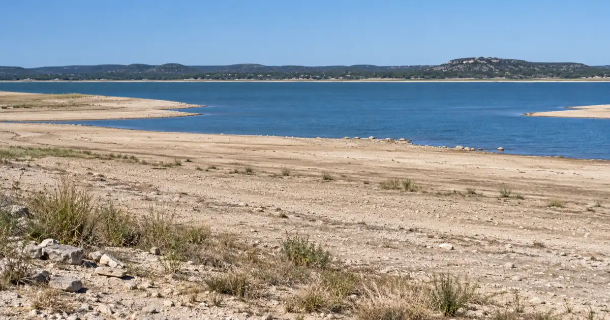 Low water exposes the sandy shoreline of Lake Buchanan near the submerged Old Bluffton townsite