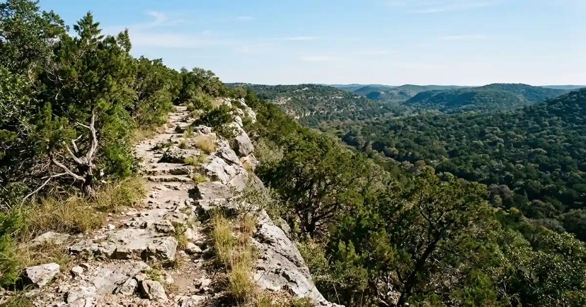 Rocky limestone ridge hiking path overlooking wooded Balcones Escarpment hills at Friedrich Wilderness Park
